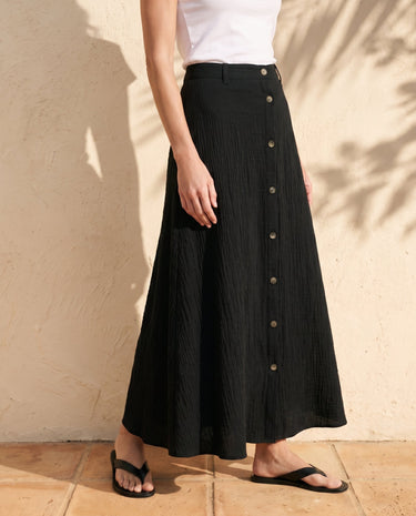 Kyra Flow A Line Skirt in black — flowing A-line maxi skirt, side view on model