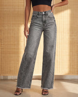 Model wearing the gray Langley Wide Leg Jeans, front view showing the high rise, wide leg and frayed hem, styled with a black crop top