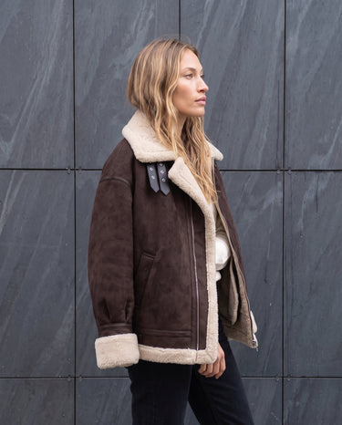 Side view of the dark brown Leni Suede Vintage Coat showing the faux shearling turn-back cuffs