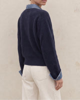 Leonie Denim Knit in navy — side-back view on model showing relaxed fit and turn-back cuffs