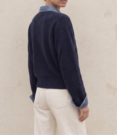 Leonie Denim Knit in navy — side-back view on model showing relaxed fit and turn-back cuffs