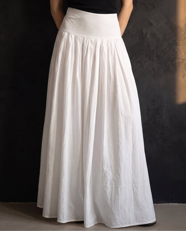 Lolie Skirt in white — front view on model, styled with a black top