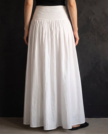 Lolie Skirt in white — full-length front view on model against a dark wall
