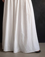 Lolie Skirt in white — cropped view showing the gathered skirt and floor-length hem