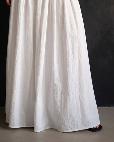 Lolie Skirt in white — cropped view showing the gathered skirt and floor-length hem