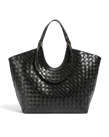 The Lucca Woven Tote in black, front view on a pure white studio background showing the basketweave body and curved handles