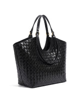 The Lucca Woven Tote in black, angled studio view showing the woven side panel and twin handles