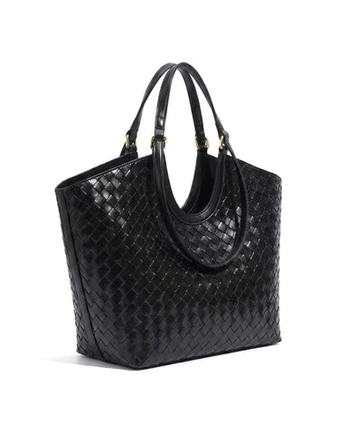 The Lucca Woven Tote in black, angled studio view showing the woven side panel and twin handles