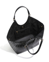 The Lucca Woven Tote in black, open top view showing the suede-lined interior and slip pockets
