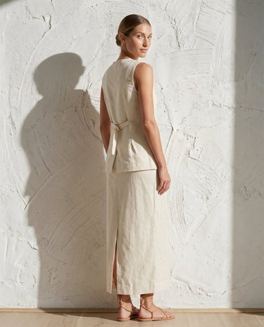 Cream sleeveless vest and maxi skirt set on model, side view – Moriel Heritage