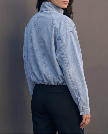 Marbella Denim Jacket — back view on model showing the raglan seams and blouson hem