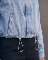 Marbella Denim Jacket — close-up of the drawcord hem and cord toggles