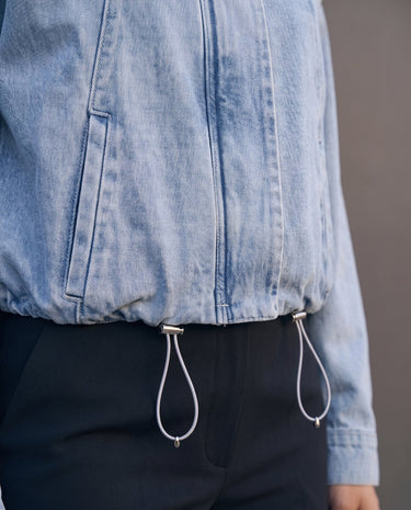Marbella Denim Jacket — close-up of the drawcord hem and cord toggles