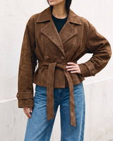 Model in the dark brown Margot Tie-waist Coat with hand on hip, front view showing the wide lapels