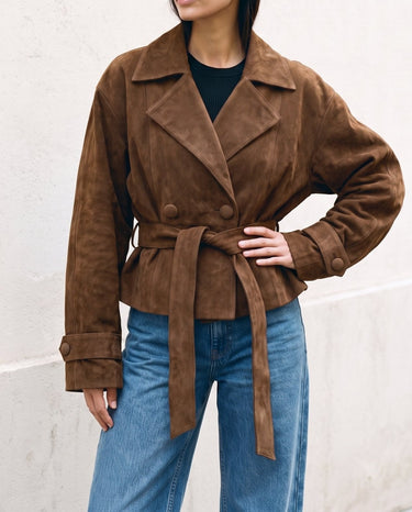 Model in the dark brown Margot Tie-waist Coat with hand on hip, front view showing the wide lapels