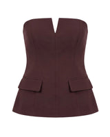Brown structured strapless top with notched V front and flap pockets, flat lay – Moriel Heritage