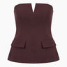 Brown structured strapless top with notched V front and flap pockets, flat lay – Moriel Heritage