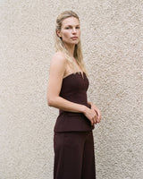 Brown structured strapless top styled as a suit set, angled full-length view – Moriel Heritage