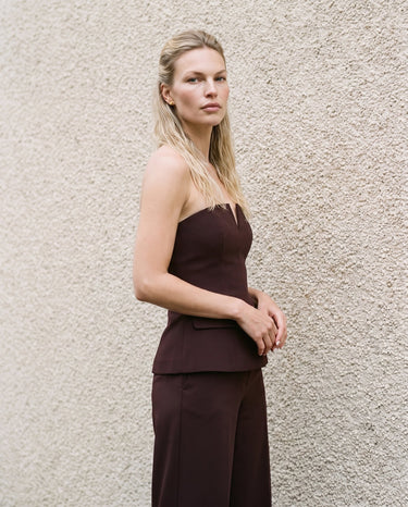 Brown structured strapless top styled as a suit set, angled full-length view – Moriel Heritage