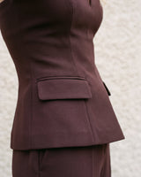 Close-up of the brown top's hip flap pocket and waist seaming – Moriel Heritage
