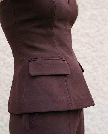 Close-up of the brown top's hip flap pocket and waist seaming – Moriel Heritage