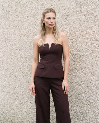 Full-length front view of the brown structured strapless top and trousers – Moriel Heritage