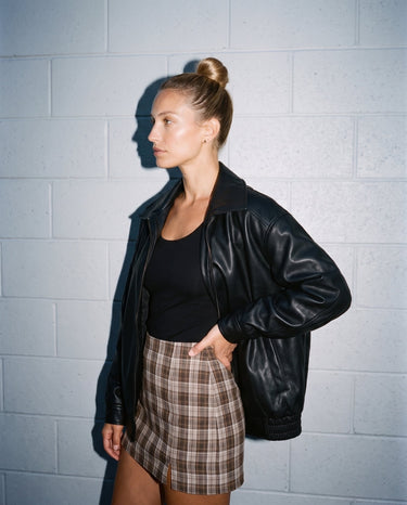 Side view of the black Marseille Faux Leather Jacket showing the relaxed oversized fit
