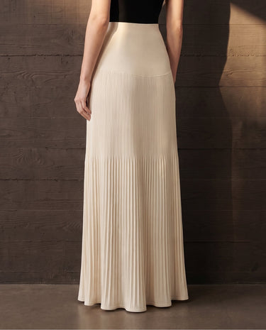 Back view of the ivory Matilde Skirt showing the smooth yoke and evenly pleated skirt flaring to the hem