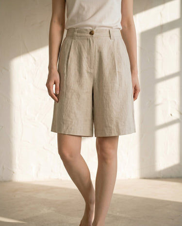 Linen-colour high-waisted shorts on model, styled with white tee – Moriel Heritage