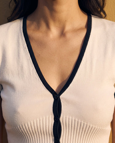 Mireva Knit Set in cream white — close-up of the V neckline and black-trimmed button placket