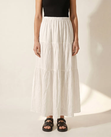 The Noemi A-Line Skirt in white — tiered maxi skirt, front view on model