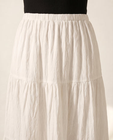 The Noemi A-Line Skirt in white — close-up of elastic waist and tiered panels