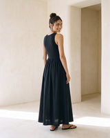 Noir Everyday Sleeveless Dress in black — sleeveless maxi dress, three-quarter back view on model