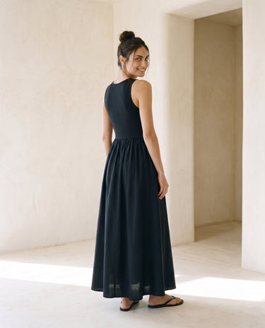 Noir Everyday Sleeveless Dress in black — sleeveless maxi dress, three-quarter back view on model