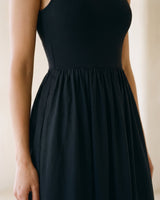 Noir Everyday Sleeveless Dress in black — close-up of fitted bodice and gathered skirt waist