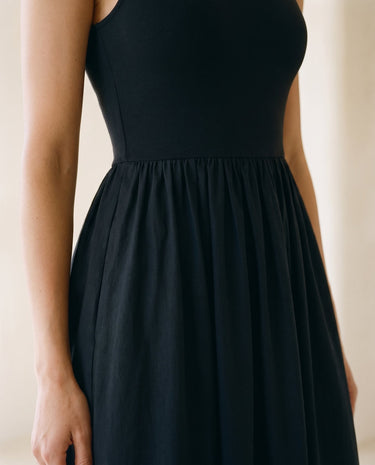 Noir Everyday Sleeveless Dress in black — close-up of fitted bodice and gathered skirt waist