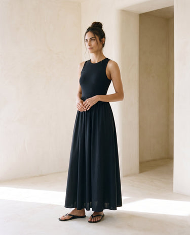 Noir Everyday Sleeveless Dress in black — sleeveless maxi dress, side view on model
