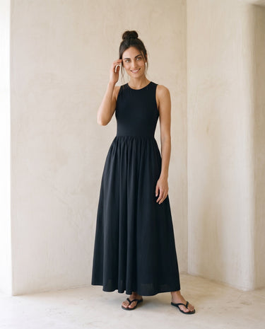 Noir Everyday Sleeveless Dress in black — crew-neck maxi dress, front styling view on model