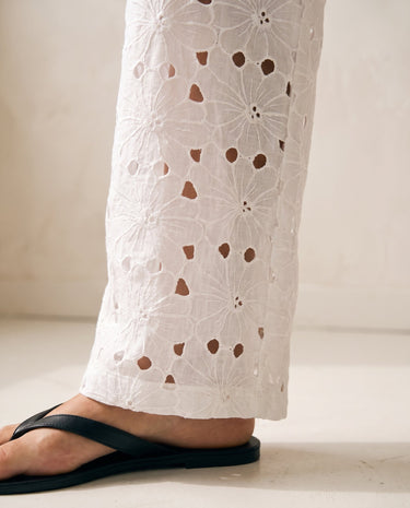 Noire Embroidered Straight Leg Pants in white — close-up of floral cutwork embroidery on trouser leg