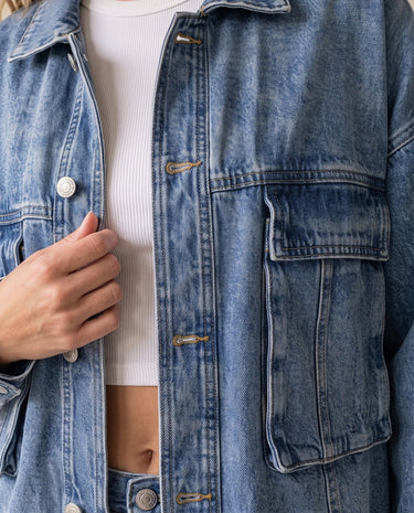 Oakley Denim Jacket in blue — close-up of flap chest pockets and button front