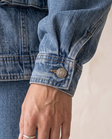Oakley Denim Jacket in blue — close-up of buttoned denim cuff
