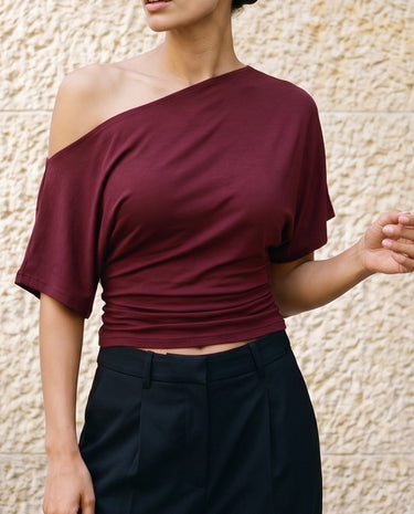 Odile Tee in burgundy — front view on model, styled with black tailored trousers