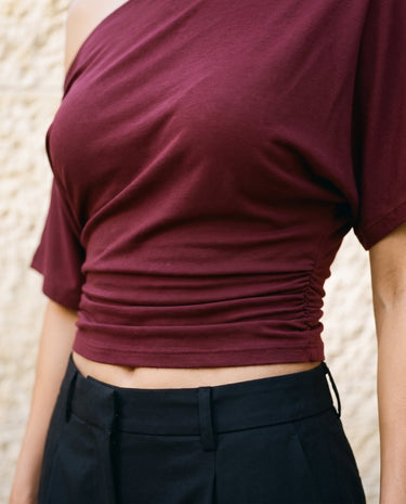 Odile Tee in burgundy — cropped front view showing the ruched waist and cropped hem