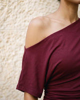Odile Tee in burgundy — close-up of the off-shoulder neckline and soft drape