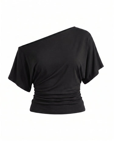 Odile Tee in black — asymmetric off-shoulder draped knit top with dolman sleeves, flat-lay
