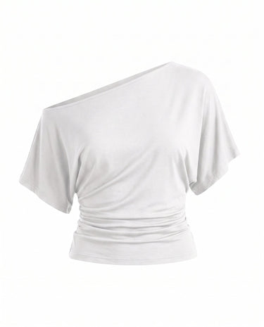 Odile Tee in white — asymmetric off-shoulder draped knit top with dolman sleeves, flat-lay