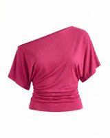 Odile Tee in pink — asymmetric off-shoulder draped knit top with dolman sleeves, flat-lay