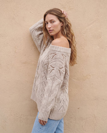 The Off Shoulder Cable Knit Sweater in khaki — off-shoulder cable-knit sweater, side view on model