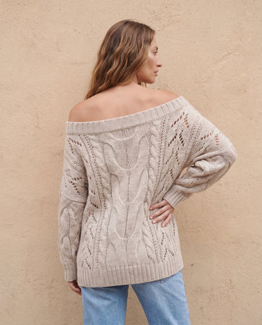 The Off Shoulder Cable Knit Sweater in khaki — off-shoulder cable-knit sweater, back view on model