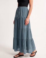 Olivia A-Line Skirt in blue — tiered maxi skirt, front three-quarter view on model